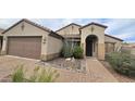 Inviting home with a two-car garage and desert landscaping along a brick walkway at 3002 W Caravaggio Ln, Phoenix, AZ 85086
