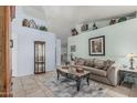 Relaxing living area with tiled floors, a comfortable sofa, and decorative accents on the walls at 3059 E Tyson Ct, Gilbert, AZ 85295