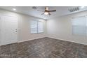 Bright bedroom with neutral walls, two windows, a ceiling fan, and tile flooring at 425 S 93Rd Pl, Mesa, AZ 85208
