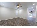 Neutral bedroom with a ceiling fan, tile flooring, and a window for natural light at 425 S 93Rd Pl, Mesa, AZ 85208