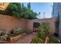 Private backyard with raised garden beds and a barbecue grill creating an ideal space for outdoor cooking at 4431 N 21St Pl, Phoenix, AZ 85016