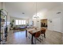 Bright living room with a dining area, neutral sofa, and access to a home gym at 4558 E Libby St, Phoenix, AZ 85032
