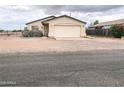 Inviting single-level home featuring an attached garage, desert landscaping, and quaint curb appeal at 5122 E Shadow Ln, San Tan Valley, AZ 85140