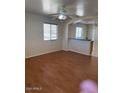 An open-concept living room featuring wood floors and a ceiling fan at 5122 E Shadow Ln, San Tan Valley, AZ 85140