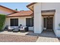 Inviting entryway with a cozy patio seating area and decorative front door at 5415 E Juniper Ave, Scottsdale, AZ 85254