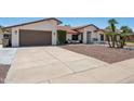 Attractive single-story house showcasing a tile roof, desert landscaping, and a wide driveway at 5415 E Juniper Ave, Scottsdale, AZ 85254