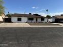 Traditional one-story home exterior with a simple front yard design and driveway at 5539 W Wilshire Dr, Phoenix, AZ 85035