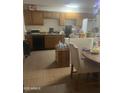 Functional kitchen with wooden cabinets and essential appliances at 6226 W Citrus Way, Glendale, AZ 85301
