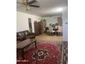 Spacious living area with tile floors, a ceiling fan, and a leather sofa at 6226 W Citrus Way, Glendale, AZ 85301