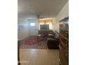 Comfortable living room with tile floors, a ceiling fan, and a leather sofa at 6226 W Citrus Way, Glendale, AZ 85301