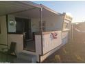 Side view of the home exterior featuring a cozy patio area with space to sit outside at 701 S Dobson Rd # 438, Mesa, AZ 85202