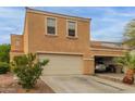 Inviting two-story townhome featuring attached two-car garage and well-maintained desert landscaping at 7064 W Lincoln St, Peoria, AZ 85345