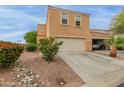 Inviting two-story townhome featuring attached two-car garage and well-maintained desert landscaping at 7064 W Lincoln St, Peoria, AZ 85345