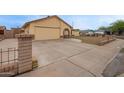 Single-story home with an attached two-car garage and brick-lined driveway at 7114 W Oregon Ave, Glendale, AZ 85303