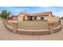 Charming single-story home with a well-maintained yard and decorative brick fence at 7114 W Oregon Ave, Glendale, AZ 85303
