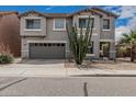 Two-story home with a two-car garage, landscaped front yard, and a decorative Southwestern desert plants at 7308 S 29Th Ln, Phoenix, AZ 85041