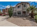 Two-story home with a two-car garage, desert landscaping with rocks, cactus and a palm tree at 7308 S 29Th Ln, Phoenix, AZ 85041
