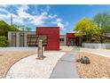 Striking facade with gravel yard, stepping stone walkway, and modern, artistic desert landscaping at 8314 E Vista Dr, Scottsdale, AZ 85250