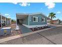 Inviting home with covered parking, landscaping, and light-blue exterior paint at 8600 E Broadway Rd # 30, Mesa, AZ 85208
