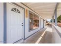 Welcoming entryway featuring a white front door, porch, and covered walkway at 8802 W Monterey Way, Phoenix, AZ 85037