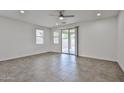 Spacious living room featuring tiled floors, abundant natural light and slider leading to the patio at 9072 W Myrtle Ave, Glendale, AZ 85305