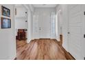 Bright entryway with wood floors, white walls, doors with sidelights and a view into multiple rooms at 9157 W Country Club Trl, Peoria, AZ 85383