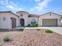 Beautiful home exterior with a tiled roof, desert landscaping, a charming arched entryway, and multiple garages at 9157 W Country Club Trl, Peoria, AZ 85383