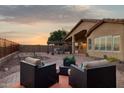 Beautiful backyard patio featuring desert landscaping, comfortable seating areas, and a charming pergola at 10109 E Trailhead Ct, Gold Canyon, AZ 85118