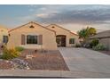 Charming single-story home featuring desert landscaping, a concrete driveway, and a cozy front porch at 10109 E Trailhead Ct, Gold Canyon, AZ 85118