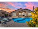 Backyard view of a sparkling blue swimming pool with lounge chairs and patio area at 10305 E Plata Ave, Mesa, AZ 85212