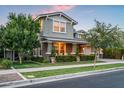 Inviting two-story home with well-maintained landscaping, covered porch, and attached garage at 10344 E Trillium Ave, Mesa, AZ 85212