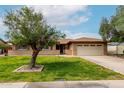 Charming single-story brick home featuring a well-maintained lawn and an attached two-car garage at 1062 E Watson Dr, Tempe, AZ 85283