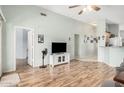 Spacious living room with laminate floors, ceiling fan, and neutral paint at 10755 W Mountain View Dr, Avondale, AZ 85323