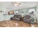 Inviting living room showcasing laminate floors, comfortable seating, and natural light at 10755 W Mountain View Dr, Avondale, AZ 85323