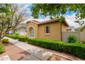Side view of a stucco house with manicured hedges and a well-maintained sidewalk at 1162 S Agnes Ln, Gilbert, AZ 85296
