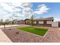 Beautiful single-story home with solar panels, manicured lawn, and desert landscaping for low maintenance appeal at 126 E Mclellan Rd, Mesa, AZ 85201