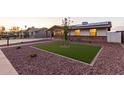 Charming single-story home with solar panels, a manicured lawn and low maintenance desert landscaping at 126 E Mclellan Rd, Mesa, AZ 85201