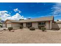 A cozy home with desert landscaping, showcasing its neutral color palette and well-maintained exterior at 1332 E Redfield Rd, Tempe, AZ 85283