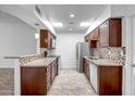 Bright kitchen featuring stainless steel appliances, tile backsplash, and ample counter space at 13424 N Emberwood Dr, Sun City, AZ 85351