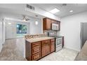 Well-lit kitchen featuring tile backsplash, stainless steel appliances, and updated cabinets at 13424 N Emberwood Dr, Sun City, AZ 85351