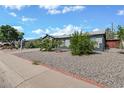 Charming single-story home featuring a gray exterior, well-maintained landscaping, and a two-car garage at 13608 N 33Rd Ave, Phoenix, AZ 85029