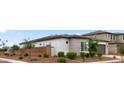Side view of a home, nicely landscaped with a brick wall and desert landscaping at 14587 W Alexandria Way, Surprise, AZ 85379