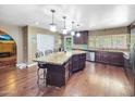Bright kitchen features stainless steel appliances, granite countertops, and a large kitchen island at 154 E Redfield Rd, Chandler, AZ 85225