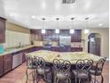 Bright kitchen features stainless steel appliances, granite countertops, and a large kitchen island at 154 E Redfield Rd, Chandler, AZ 85225