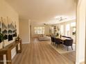 Open-concept living and dining area featuring wood floors and neutral decor at 17911 N Adobe Mesa Ct, Surprise, AZ 85374