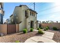 Beautiful house with stucco siding, desert landscaping, and a walkway leading to the front door at 17970 N 114Th Ln, Surprise, AZ 85378