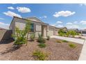 Single-story home with desert landscaping and a two-car garage is shown on a sunny day at 18492 E Donato Dr, Gold Canyon, AZ 85118