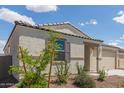 Single-story home with desert landscaping and a two-car garage is shown on a sunny day at 18492 E Donato Dr, Gold Canyon, AZ 85118