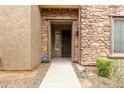 Inviting stone entryway with an ADT security system at 2042 W Mark Ln, Phoenix, AZ 85085