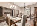 Bright, open-concept living room with hardwood floors, a dining area, and neutral decor at 2042 W Mark Ln, Phoenix, AZ 85085